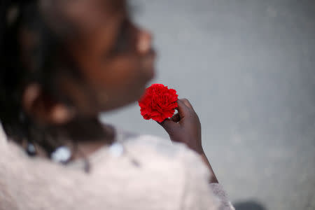FILE PHOTO: A girl holds a carnation during a march marking the Carnation Revolution's 43rd anniversary in Lisbon, Portugal April 25, 2017. REUTERS/Rafael Marchante/File Photo