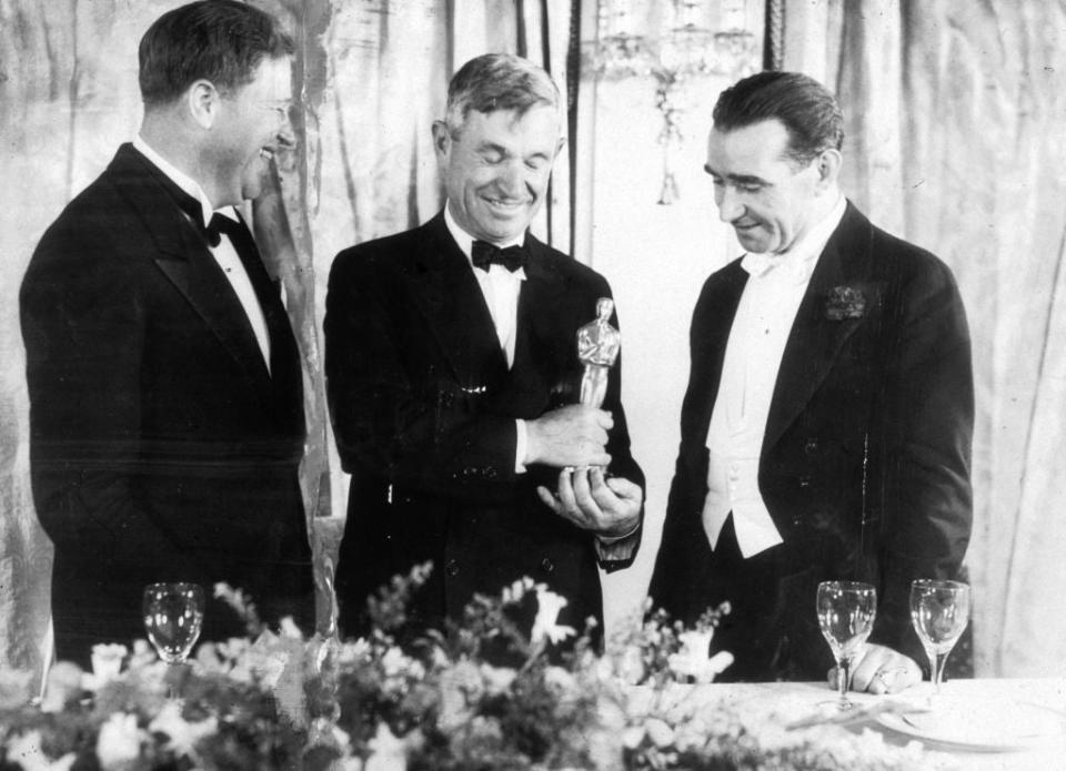 Franklin Hansen, Will Rogers, and Frank Lloyd in black-tie attire laugh joyfully at an awards ceremony