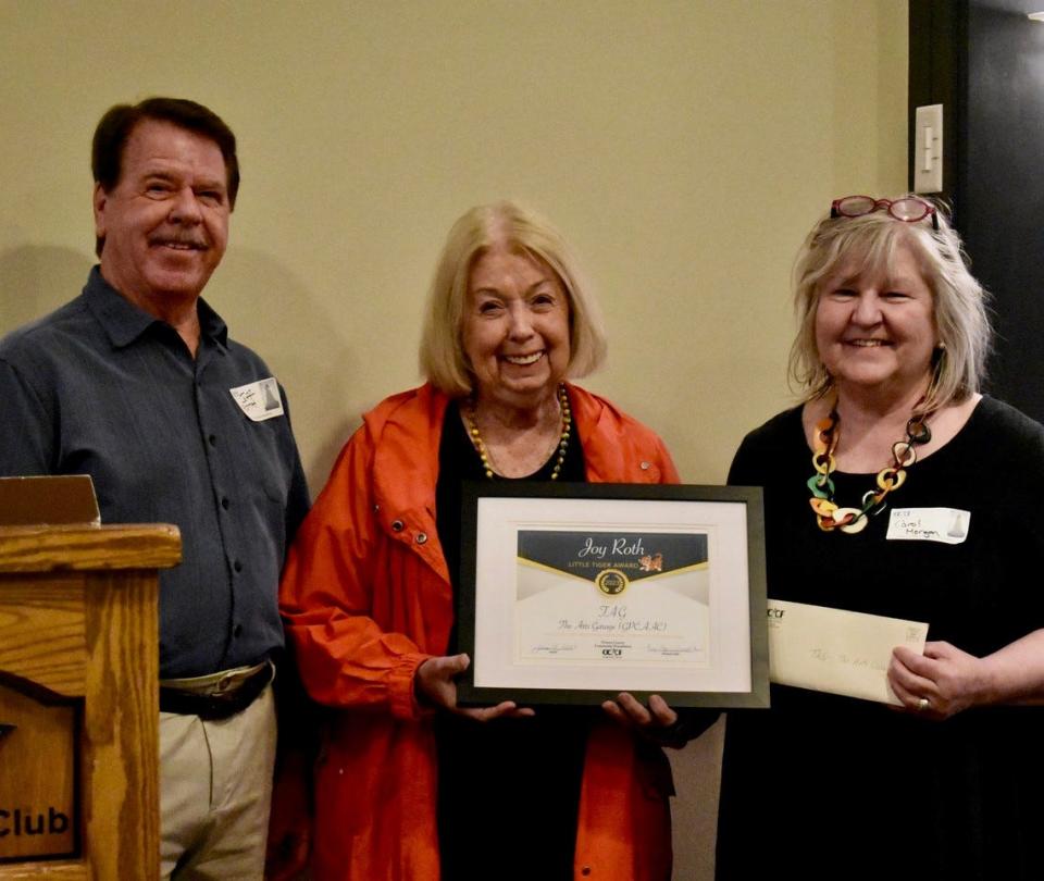 Jonnie Myers-Debbink, center, and Carol Morgan, right receive the Joy Roth Little Tiger Award, presented by Jeff Roth, left.