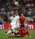 Xabi Alonso of Spain challenges Florent Malouda of France during the UEFA EURO 2012 quarter final match between Spain and France at Donbass Arena on June 23, 2012 in Donetsk, Ukraine. (Photo by Laurence Griffiths/Getty Images)