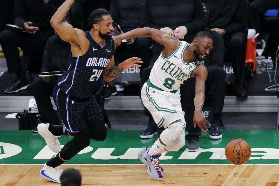 Orlando Magic's Khem Birch (24) fouls Boston Celtics' Kemba Walker (8) during the first half on an NBA basketball game, Sunday, March 21, 2021, in Boston. (AP Photo/Michael Dwyer)