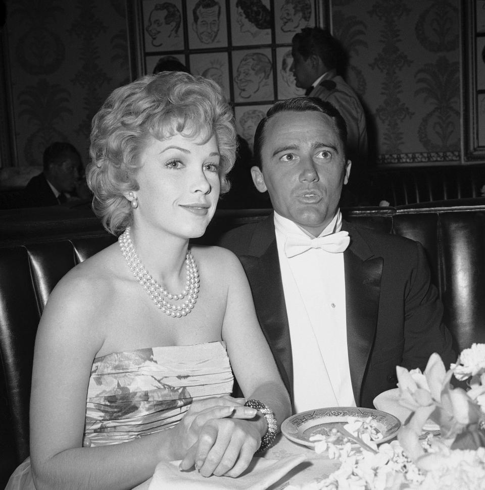 FILE - Actress Stella Stevens and actor Robert Vaughn, a nominee for best supporting actor of the year for "The Young Philadelphians," arrive at the Academy Award fashion show which preceded the Oscar presentations in Hollywood, April 4, 1960. Stevens, a prominent leading lady in 1960s and '70s comedies who is perhaps best known for playing the object of Jerry Lewis’s affection in “The Nutty Professor,” died Friday. She was 84. (AP Photo, File)