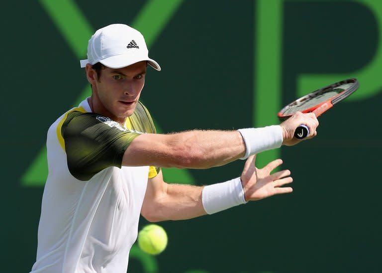 Andy Murray of Scotland runs to play a backhand against Bernard Tomic of Australia during their second round match at the Sony Open at Crandon Park Tennis Center on March 23, 2013 in Key Biscayne, Florida. Murray, the reigning Olympic and US Open champion, advanced to the third round of the WTA and ATP Miami Masters by routing Tomic 6-3, 6-1