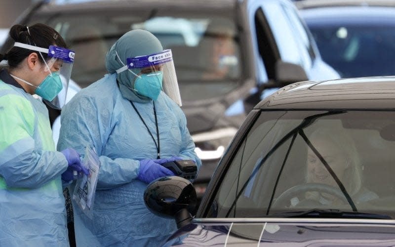 FILE PHOTO: Medical workers administer tests at the Bondi Beach drive-through coronavirus disease (COVID-19) testing centre in the wake of new positive cases in Sydney, Australia, June 17, 2021.  - Reuters