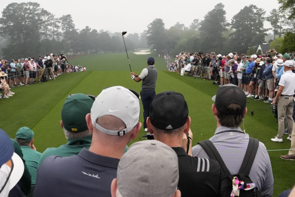 Tiger Woods hits from the first tee during a practice for the Masters golf tournament.