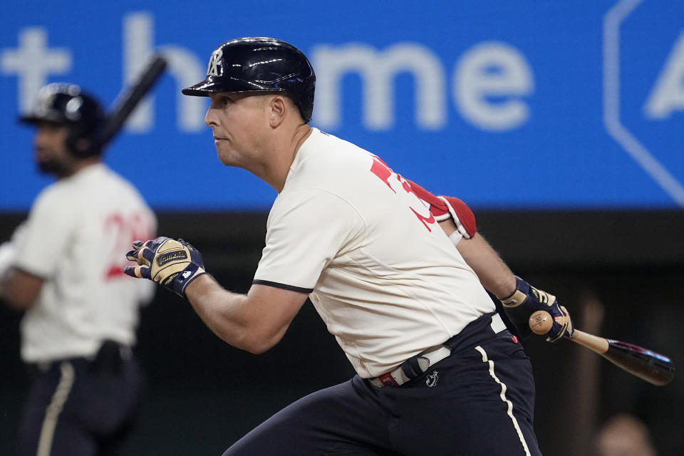 Texas Rangers' Nathaniel Lowe follows through on a run-scoring single in the sixth inning of a baseball game against the Oakland Athletics, Saturday, Sept. 9, 2023, in Arlington, Texas. Robbie Grossman scored on the hit. (AP Photo/Tony Gutierrez)