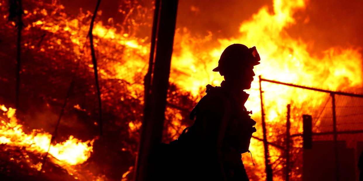 A firefighter battles the Alisal fire along the 101 Freeway near Goleta on Tuesday, Oct. 12, 2021.