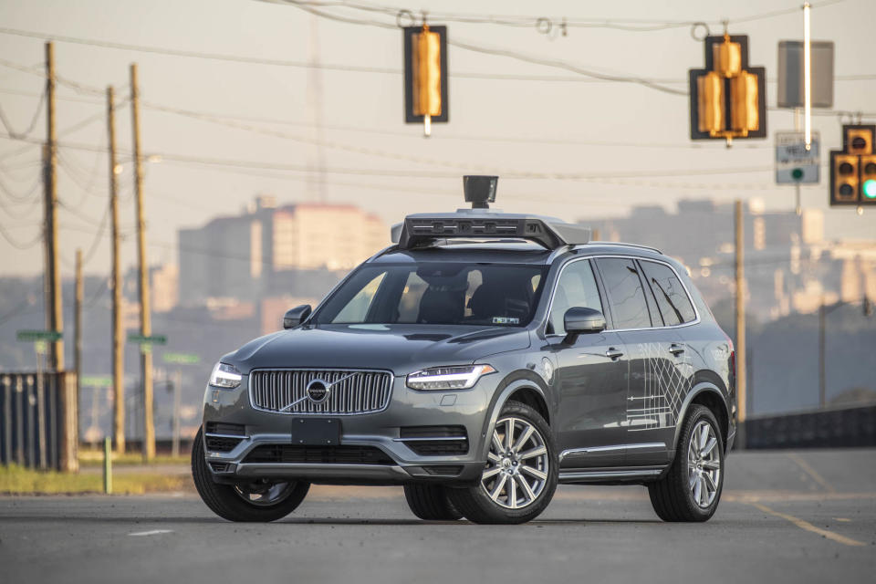 An autonomous SUV with Uber branding.