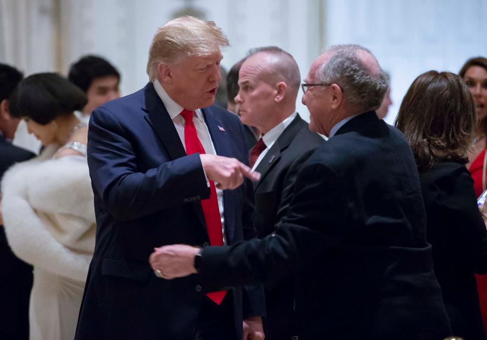 President Donald Trump talks with attorney Alan Dershowitz before Christmas dinner in the ballroom at Mar-a-Lago in Palm Beach, Dec. 24, 2019.