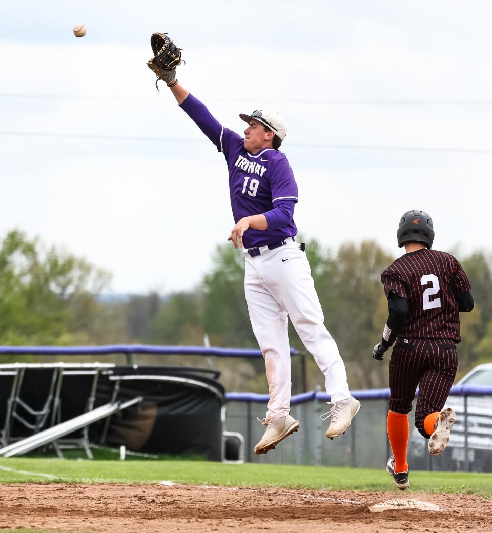 Triway's Kade Whitman has the hops here, leaping high to catch this off-target throw.