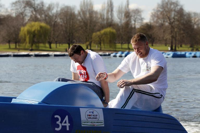 Former England cricketer Andrew Flintoff (R) and England cricketer Steve Harmison attempt to break the fastest 100m in a pedalo record in London on March 19, 2012