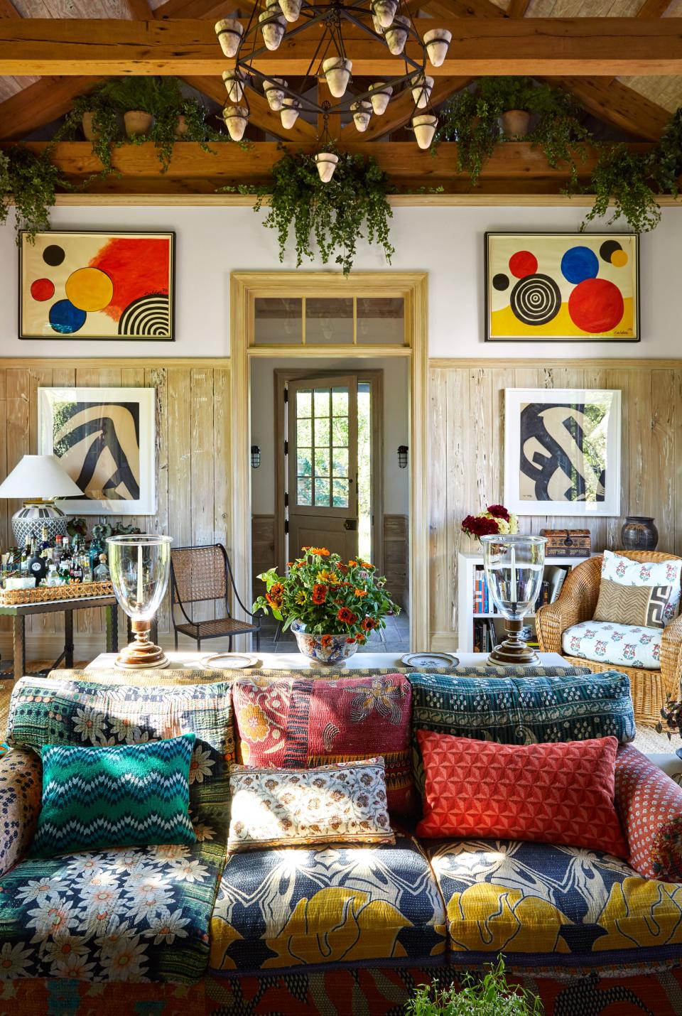 A brilliantly patterned Billy Baldwin Studio sofa is at the center of the living area in the party barn, hung with Alexander Calder gouaches.