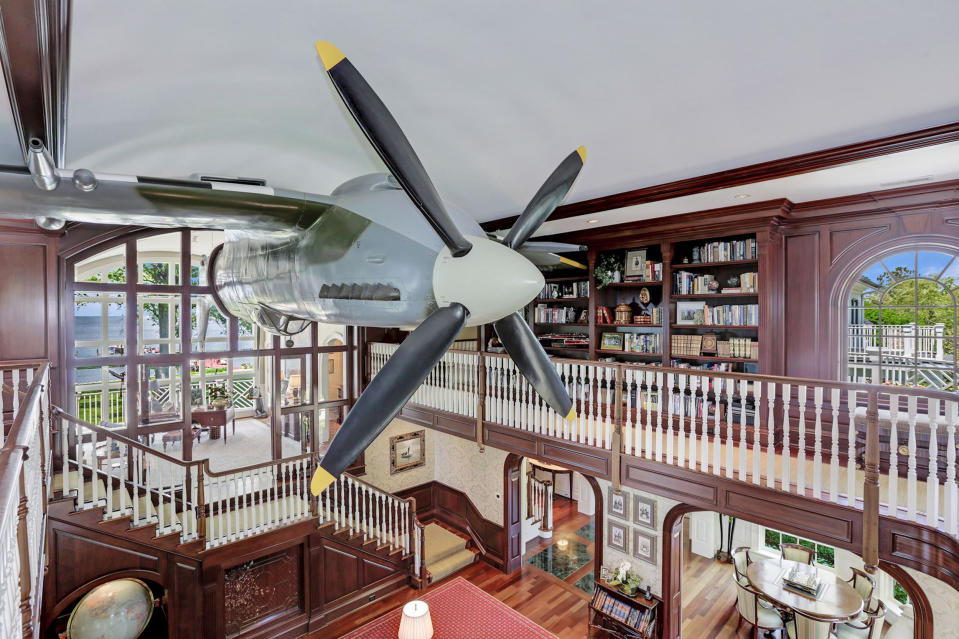 A second home owned by the same owner, also for sale, features a real plane hanging from the living room ceiling.  (Home Visit)