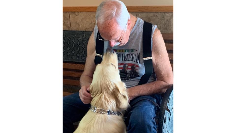 A veteran sits with his service dog. (Courtesy of Northwest Battle Buddies)