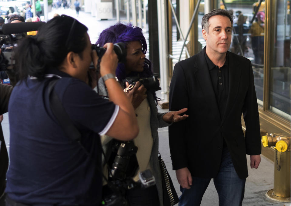 FILE - In this Saturday, May 4, 2019, file photo, Michael Cohen, President Donald Trump's former personal attorney, is confronted by members of the media as he heads back to his Park Avenue apartment in New York. Cohen has until Monday afternoon, May 6, 2019, to report to a federal prison where he’ll begin his three-year sentence. Cohen is the only person charged in connection with hush-money payments to women who allegedly had affairs with Trump. (AP Photo/Jonathan Carroll, File)