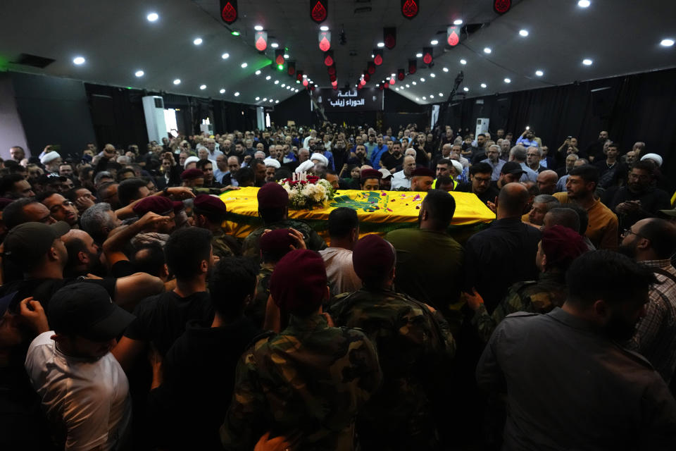 Hezbollah fighters carry the coffin of their comrade, Mohammed Ali Assaf, who was killed by an Israeli strike in Syria Friday morning, during his funeral procession in the southern Beirut suburb of Dahiyeh, Lebanon, Saturday, Nov. 11, 2023. Lebanon's militant Hezbollah group has announced the death of seven of its fighters without giving details on where they were killed. A Hezbollah official and a Lebanese security official said the seven fighters were killed in neighboring Syria Friday morning. (AP Photo/Hassan Ammar)