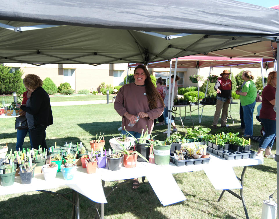 A vendor shows off her plants at the Randall County Master Gardeners plant sale Saturday as part of Gardenfest at the Texas A&M AgriLife Extension Center in Amarillo.