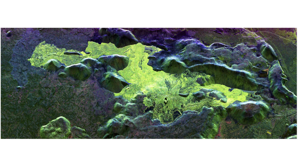 radar image of a lava field, featuring greenish patches of fresher lava against a dark background of older deposits.