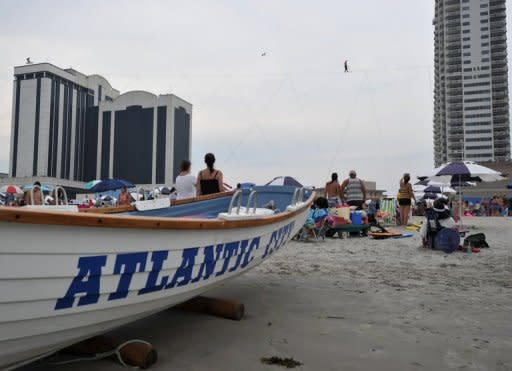 Nik Wallenda, the American man who recently walked across a wire strung over Niagara Falls, hit the Atlantic City beach for a stroll Thursday -- 100 feet above the beach, to be exact