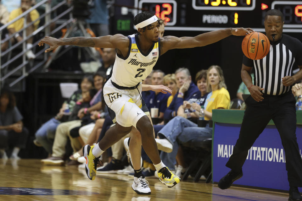 Marquette guard Chase Ross (2) steals the ball away from Purdue during the first half of an NCAA college basketball game, Wednesday, Nov. 22, 2023, in Honolulu. (AP Photo/Marco Garcia)