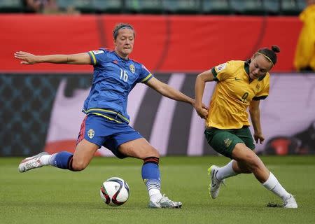 Jun 16, 2015; Edmonton, Alberta, CAN; Sweden defender Lina Nilsson (16) battles for the ball with Australia forward Caitlin Foord (9) during the second half in a Group D soccer match in the 2015 FIFA women's World Cup at Commonwealth Stadium. Mandatory Credit: Erich Schlegel-USA TODAY Sports