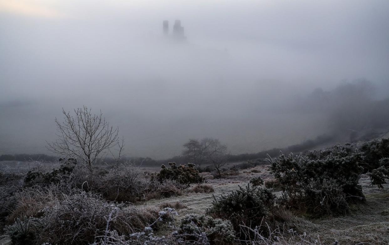 A yellow weather warning for freezing fog has been issued on Christmas day by the Met Office. Pictured is Corfe Castle, in Dorset. PA.