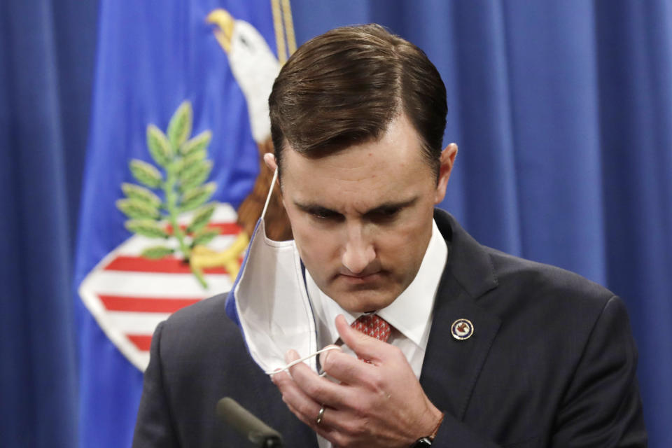 Acting Assistant Attorney General Brian Rabbitt for the Justice Department's Criminal Division removes a face mask to speak at the Justice Department, Thursday, Oct. 22, 2020, in Washington. A subsidiary of Goldman Sachs pleaded guilty on Thursday and agreed to pay more than $2 billion in a foreign corruption probe tied to the Malaysian 1MDB sovereign wealth fund, which was looted of billions of dollars in a corruption scandal. The company, Goldman Sachs Malaysia, entered the plea in federal court in Brooklyn. (Yuri Gripas/The New York Times via AP, Pool)