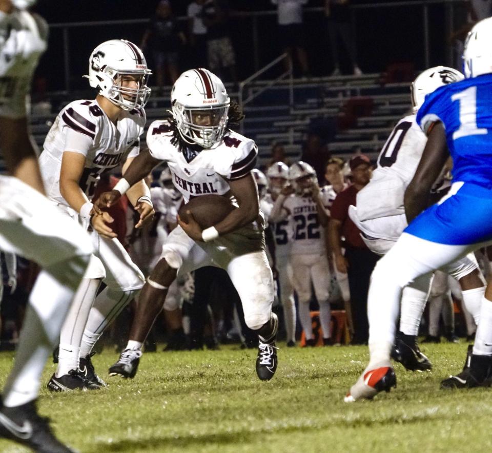 Palm Beach Central running back Zequan Wright (4) takes the handoff from quarterback Caleb Butler (14) against Pahokee on Thursday, Sept. 14, 2023 in Pahokee.