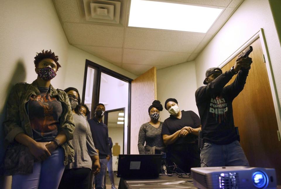 Anubis Heru, right, lead trainer, runs a pistol and safety class at 1770 Armory and Gun Club, Colorado’s first Black-owned shooting range, Saturday, Oct. 24, 2020 in Denver. (Rachel Ellis/The Denver Post via AP)