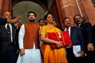 India's Finance Minister Nirmala Sitharaman is flanked by junior Finance Minister Anurag Thakur as she arrives to present the budget in Parliament in New Delhi
