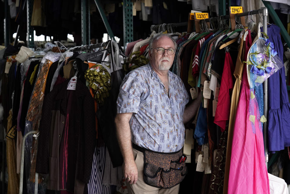 Shon LeBlanc, co-owner of costume rental service Valentino's Costume Group, poses for a portrait amongst racks of clothing at his warehouse, Friday, May 26, 2023, in Los Angeles. (AP Photo/Chris Pizzello)