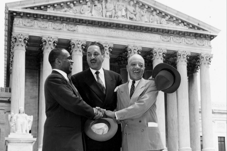 FILE - This May 17, 1954, file photo shows, from left, George E.C. Hayes, Thurgood Marshall, and James M. Nabrit joining hands as they pose outside the Supreme Court in Washington. The three lawyers led the fight for abolition of segregation in public schools before the Supreme Court, which ruled that segregation is unconstitutional. (AP Photo/File)