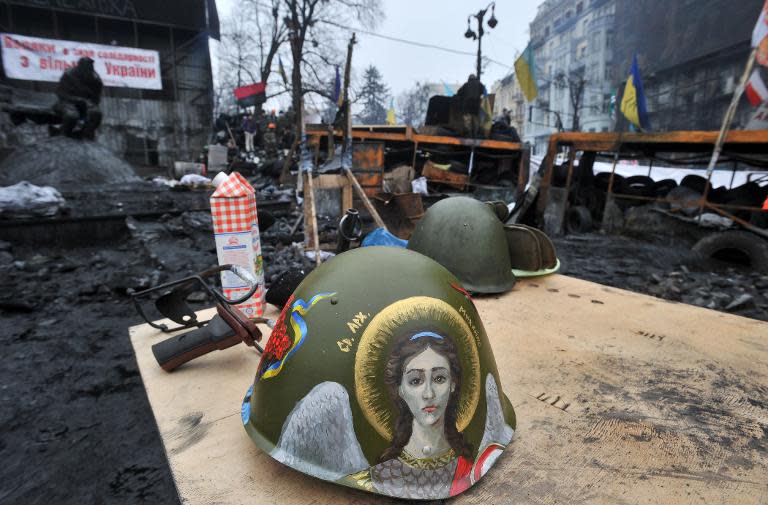 A protester’s helmet decorated with an icon is seen in front of barricades on Grushevsky street in Kiev on February 9, 2014