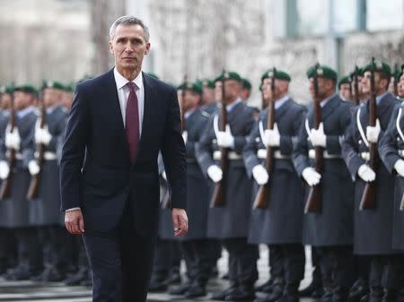 NATO Secretary General Jens Stoltenberg reviews a guard of honour during a welcoming ceremony at the Chancellery in Berlin January 14, 2015. REUTERS/Hannibal Hanschke