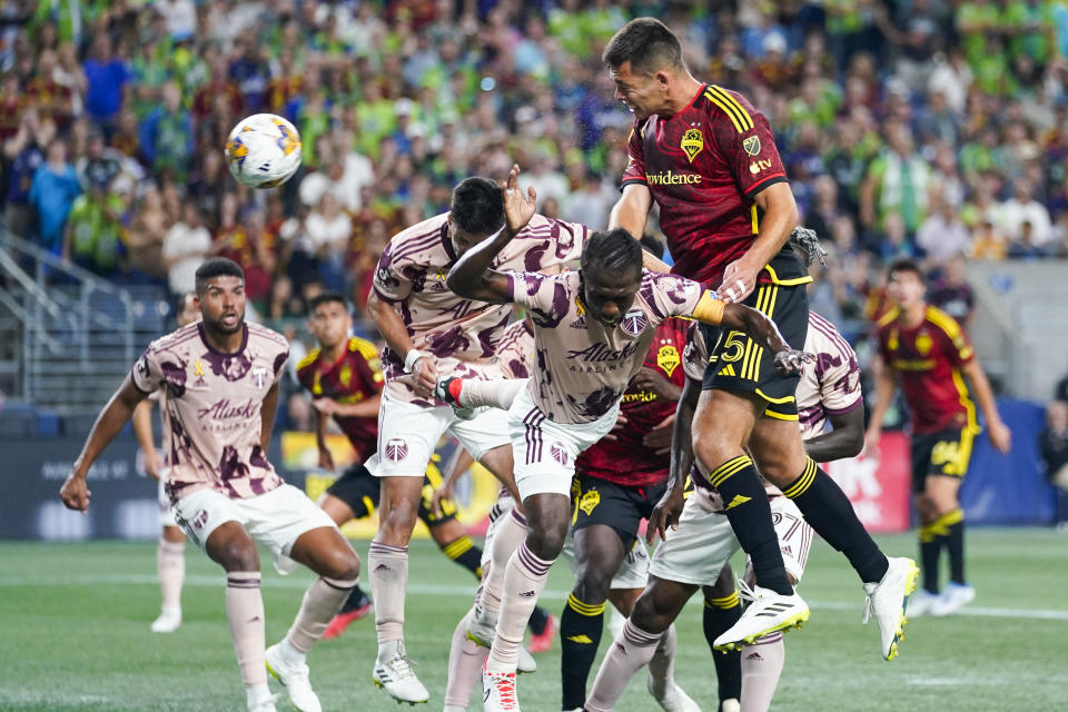 Seattle Sounders defender Jackson Ragen (25) goes up for a header on a corner kick against Portland Timbers midfielder Diego Chará, bottom center, during the second half of an MLS soccer match Saturday, Sept. 2, 2023, in Seattle. The teams played to a 2-2 draw. (AP Photo/Lindsey Wasson)