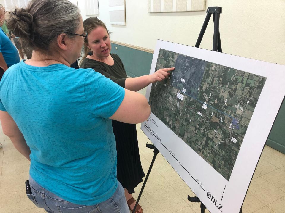 At the open house on trails to Potato Creek State Park, a North Liberty area resident looks at options with Caitlin Stevens, transportation director for the Michiana Area Council of Governments, on July 11, 2023.