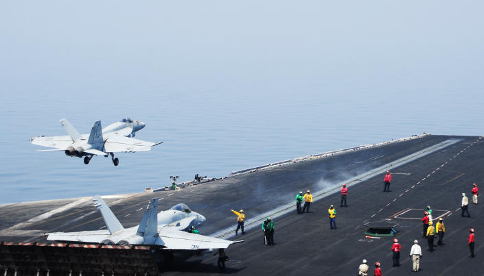 This US Navy photo obtained August 8, 2014 shows sailors directing aircraft, as an F/A-18E Super Hornet takes off from the aircraft carrier USS George H.W. Bush on August 1, 2014 in the Gulf (AFP Photo/Joshua Card)