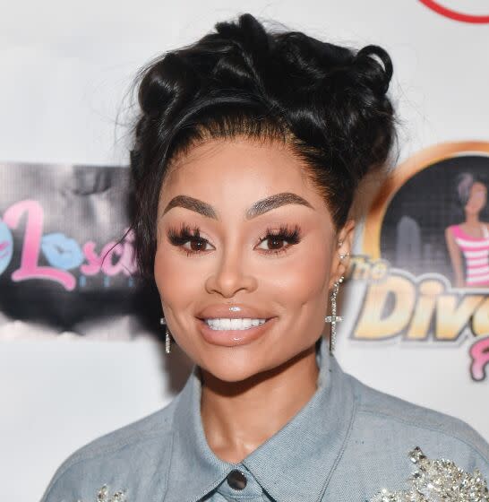 Blac Chyna with her hair in a bun smiling