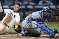 Tampa Bay Rays' Harold Ramirez, left, scores around the tag by Kansas City Royals catcher Salvador Perez on a two-run single by Randy Arozarena during the sixth inning of a baseball game Friday, Aug. 19, 2022, in St. Petersburg, Fla. (AP Photo/Chris O'Meara)