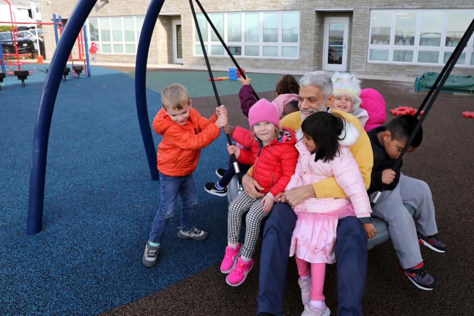Howard Milbert, executive director of the Ossining Children's Center, swings with pre-k students on the playground Nov. 8, 2023. The center is a not-for-profit organization and will have to do more fundraising as federal pandemic funds run out.