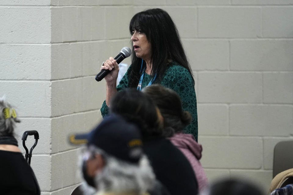 Nora Cherry speaks of her mother's time spent in an Indian boarding school in the 1930's during a "Road to Healing" event, Friday, Jan. 20, 2023, at the Gila Crossing Community School in Laveen, Ariz. The "The Road to Healing," is a year-long tour across the country to provide Indigenous survivors of the federal Indian boarding school system and their descendants an opportunity to share their experiences. (AP Photo/Matt York)