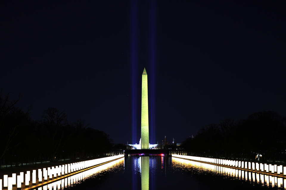 WASHINGTON, DC - JANUARY 19: Columns representing victims of coronavirus (COVID-19) are lit as they are displayed along the sides of the Lincoln Memorial Reflecting Pool after President-elect Joe Biden and Vice President-elect Kamala Harris attend a memorial on the eve of the presidential inauguration on January 19, 2021 in Washington, DC. There have been nearly 400,00 deaths in the U.S. since the first confirmed case of the virus in Seattle on January 2020. (Photo by Michael M. Santiago/Getty Images)