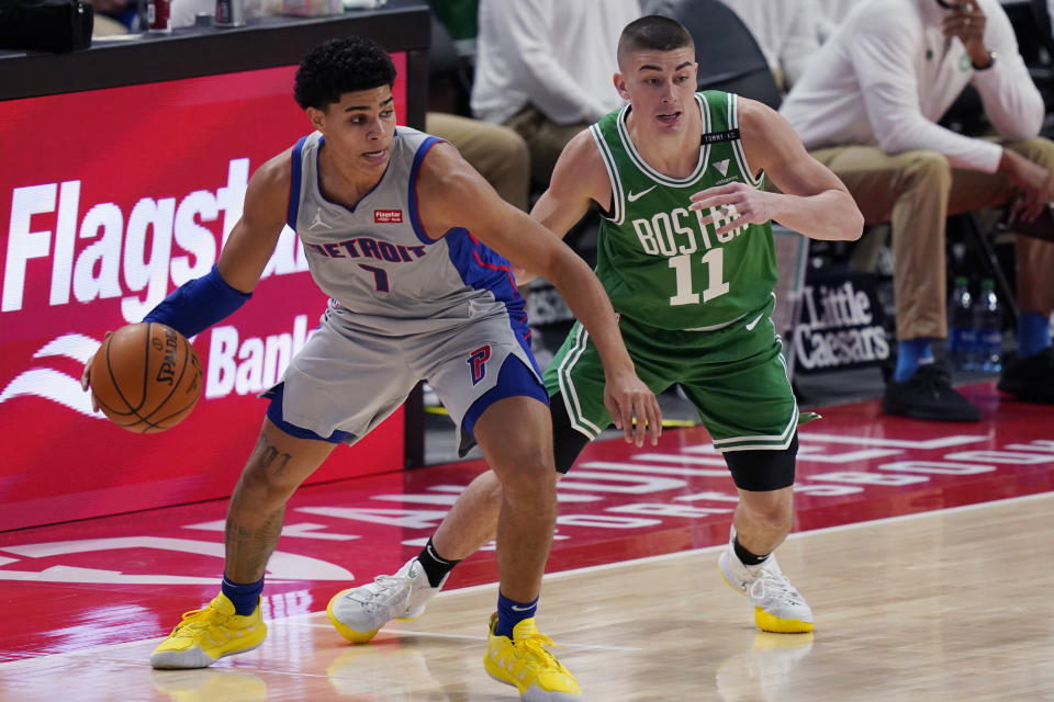 Detroit Pistons guard Killian Hayes (7) looks to pass the ball as Boston Celtics guard Payton Pritchard (11) defends during the first half of an NBA basketball game Friday, Jan. 1, 2021, in Detroit. (AP Photo/Carlos Osorio)