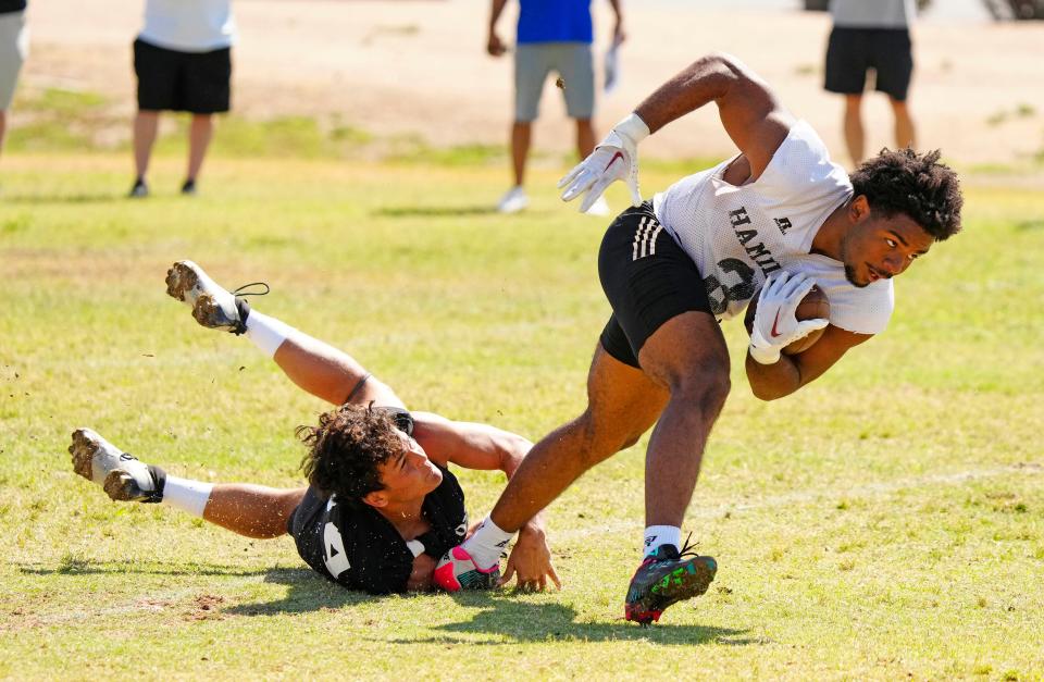 Hamilton running back Jacob Brown (3) catches a pass and turns upfield during a practice at Hamilton High School on the Chandler Unified School District Spring Football Jamboree on May 14, 2024, in Chandler, Arizona.