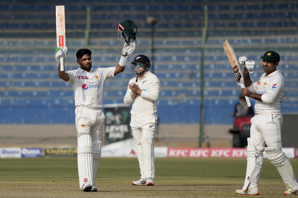 Pakistan's Babar Azam, left, celebrates after scoring century during the first day of first test cricket match between Pakistan and New Zealand, in Karachi, Pakistan, Monday, Dec. 26, 2022. (AP Photo/Fareed Khan)
