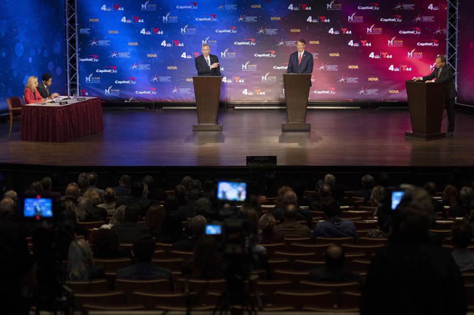 Virginia Democratic gubernatorial candidate and former Gov. Terry McAuliffe, left, and Republican challenger, Glenn Youngkin, participate in a debate at Northern Virginia Community College, in Alexandria, Va., Tuesday, Sept. 28, 2021. (AP Photo/Cliff Owen)