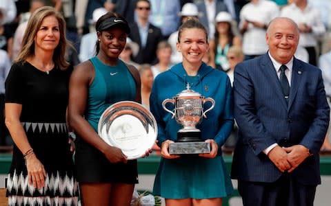 Romania's Simona Halep (2ndR), poses with her trophy next to second placed Sloane Stephens of the US (2ndL), French Tennis Federation (FFT) President Bernard Giudicelli (R) and former Spanish tennis player Arantxa SÃ¡nchez Vicario (L), after the women's singles final match against Romania's Simona Halep, on day fourteen of The Roland Garros 2018 French Open tennis tournament in Paris on June 9, 2018 - Credit: AFP