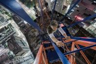 Climbing to the top of a crane to shoot the streetscape below <b>Photo - Tom Ryaboi</b>