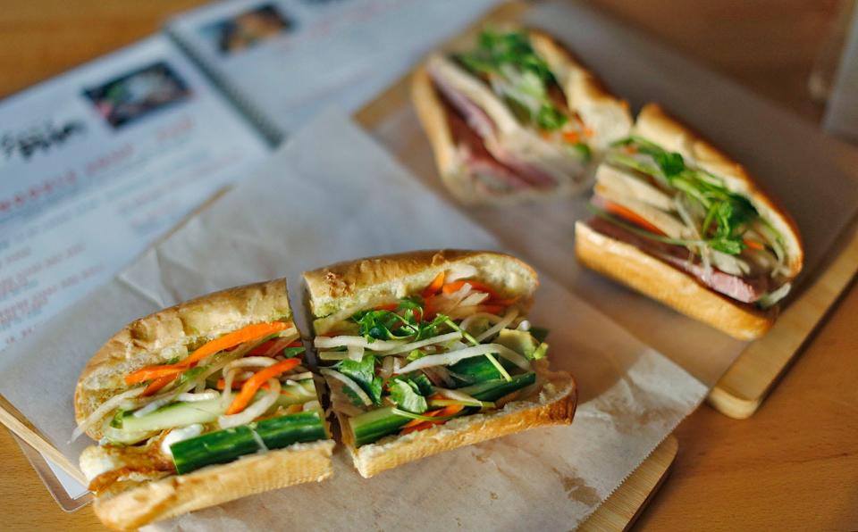 Avocado, egg and cold cuts are the ingredients in these banh mi sandwiches.