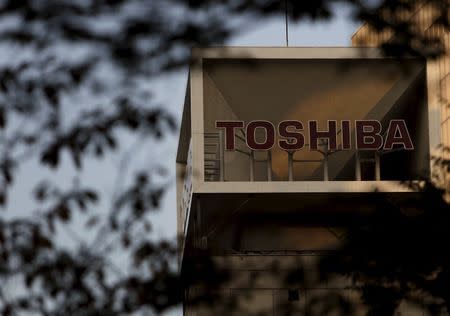 The logo of Toshiba Corp is seen behind trees at its headquarters in Tokyo, Japan, November 6, 2015. REUTERS/Yuya Shino